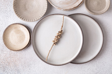 Ceramic tableware, hand-made plates. Gray background