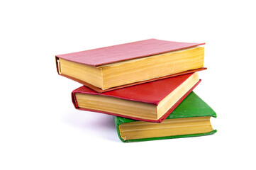 A stack of old books with colored covers. Books for reading. Old book. Book page of yellow paper. White background. Paper product. Read literature. Background picture.