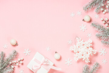 Christmas decorations at pink background. Fir tree, present box and white christmas decorations....