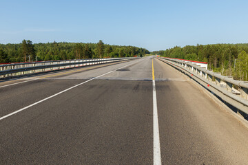 Fototapeta premium Asphalt road. Automobile bridge over the railway in Siberia.