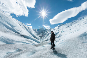 A man posing on the ice formation of the Perito Moreno Glacier