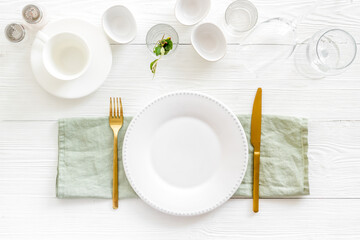 Dinnerware set with view from above - plate with cutlery and napkin