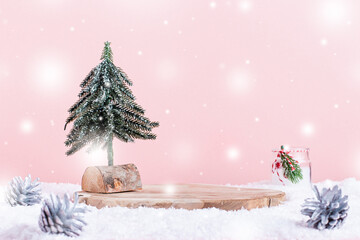 Fototapeta na wymiar Christmas holiday wooden podium or stand in snow with Christmas tree and candle