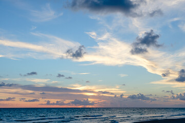 Naklejka na ściany i meble Beautiful colored cloudy evening sky. Seascape.