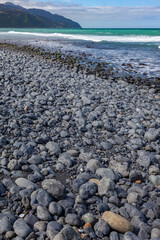 Beach near Mangamaunu strewn with small grey boulders