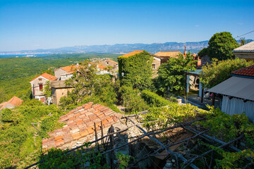 The historic medieval hill village of Dobrinj on Krk island in the Primorje-Gorski Kotar County of western Croatia. The Croatian mainland can be seen in the background
