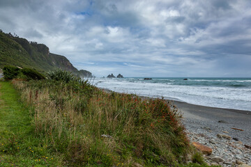 Stormy weather approaching a desolate beach in New Zealand