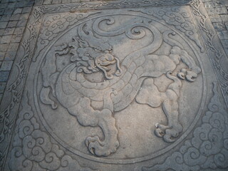 A beautiful ancient Chinese dragon pattern on the street ground in Guandu Ancient town, Khunming, China 