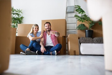 Young couple celebrating moving to new home