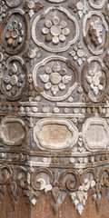 Detail of beautiful ancient Lanna style stucco on wood floral decoration on exterior of the old vihara at historic Wat Prasat buddhist temple, Chiang Mai, Thailand