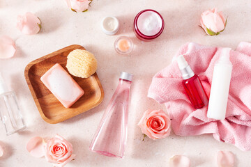 skincare products and rose flowers. natural cosmetics for home spa treatment