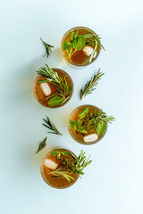 Summer cold tea and fresh herbs rosemary in glasses