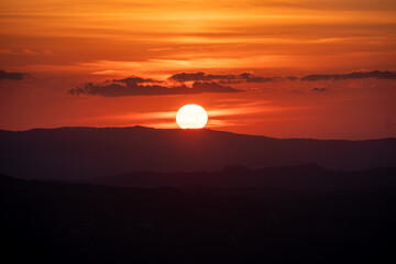 Beautiful orange sunset.  Sunset in Sardinia. Red sky over hills. Aurora effect. 