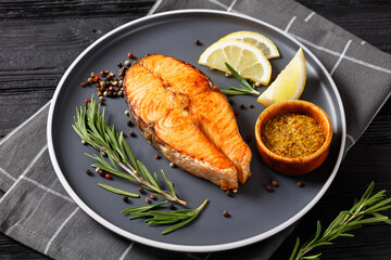 baked salmon steak on a plate, top view