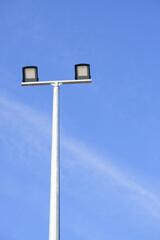 Modern park LED luminaire on a tall metal mast.
