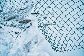 Escape from prison or closed institution for mentally ill. Hole in wire border fence. Winter snowy...