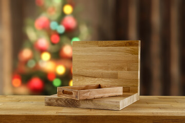 Desk of free space with wooden pedestal and christmas background. 