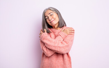 senior pretty woman feeling in love, smiling, cuddling and hugging self, staying single, being...