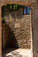 small stone alley in the medieval village of pals on the costa brava on a sunny day