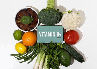A set of natural products rich in vitamin B9 folic acid. Healthy food concept. Cardboard sign with the inscription.