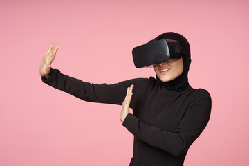 woman in black hijab glasses virtual reality technology movie watching