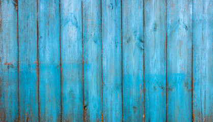 Fototapeta na wymiar Old blue wooden background with cracks and scratches in vintage style