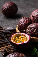 Delicious juicy passion fruit on gray table background.