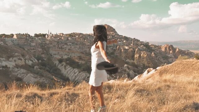 Happy caucasian woman solo out of joy spin in spot on holidays in scenic location with landmark background