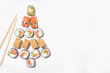 Fotobehang Christmas sushi set with funny decorated rolls like Xmas symbols – santa, deer, snowman, fir tree, Christmas sushi bar menu, festive delivery mock-up © ricka_kinamoto