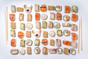Christmas sushi set with funny decorated rolls like Xmas symbols – santa, deer, snowman, fir tree, Christmas sushi bar menu, festive delivery mock-up