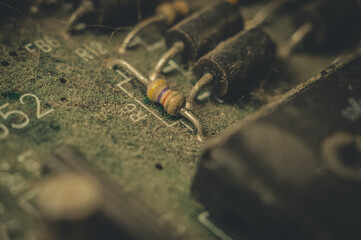 Electronic components close-up on an old computer motherboard. Dust on the surface of the parts. Selective focus