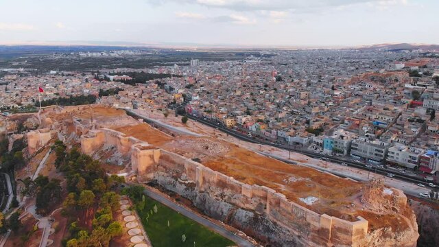 Aerial static view famous landmark top Urfa castle with colorful old town tradition architecture colorful houses background
