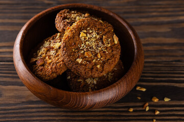 Homemade cookies with nuts in a wooden bowl. Sugar, gluten, lactose free, vegan, healthy food.