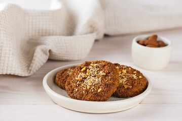 Vegan cookies with nuts on a wooden table. Sugar, gluten, lactose free, healthy food.