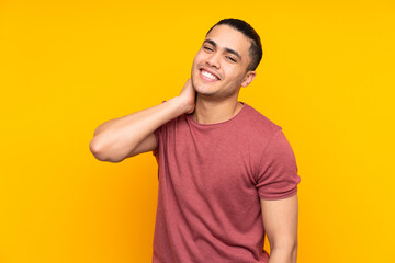 Asian handsome man isolated on yellow background doing surprise gesture while looking to the side