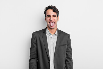 young businessman with cheerful, carefree, rebellious attitude, joking and sticking tongue out,...