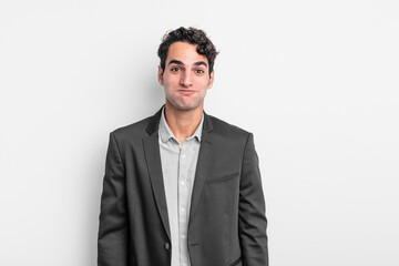 young businessman with a goofy, crazy, surprised expression, puffing cheeks, feeling stuffed, fat...