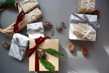  Christmas background with gift boxes and ornaments in gray color. Xmas celebration, greetings,...