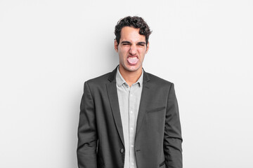 young businessman feeling disgusted and irritated, sticking tongue out, disliking something nasty...