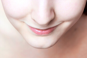 Obraz premium Young caucasian woman smiling face with clean skin and lips. Spa, skincare, cosmetics using and make up concept.