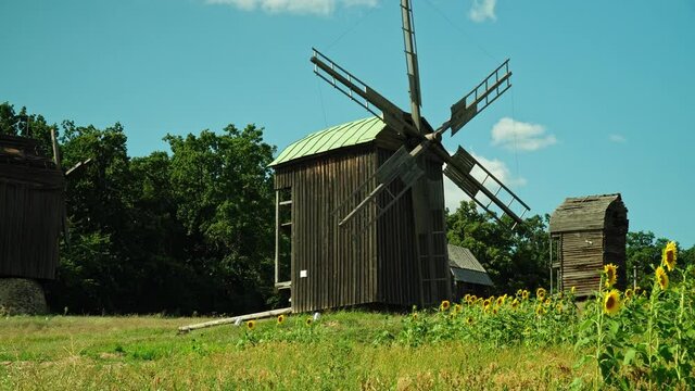 Wooden windmill in Ukrainian traditional village.