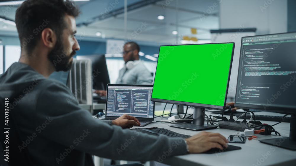 Poster Multi-Ethnic Office: White IT Programmer Working on Computer with Green Screen Chroma Key Display. Male Software Engineer Developing App, Program, Video Game. Terminal with Code Language.