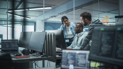 Diverse Multi-Ethnic Team Working in Modern Office: Group of IT Programmers Gather Around Desktop Computer, Talking, Finding Solution. Specialists Create Software. Engineers Develop App, Program