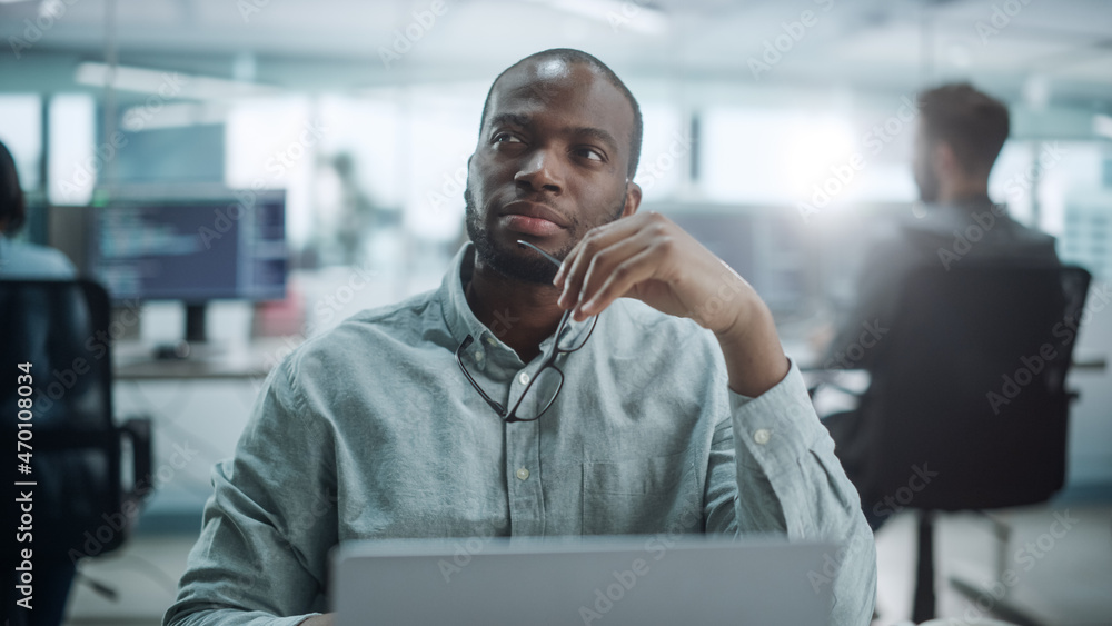 Aufkleber modern office: portrait of thoughtful black it programmer working on laptop, finding solution, solvi