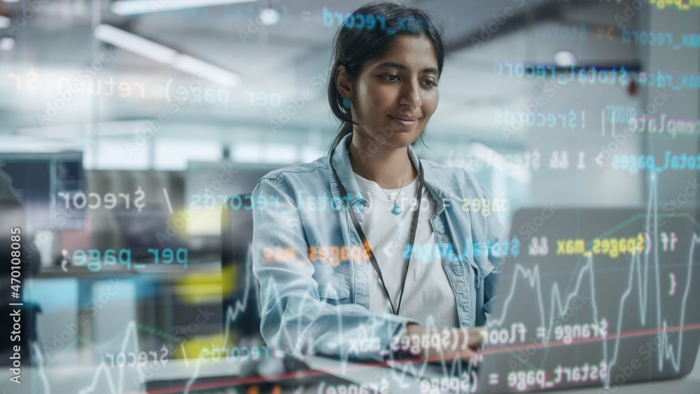 Poster Diverse Office: Portrait of Beautiful Smiling Indian IT Programmer Working on Desktop Computer. Female Specialist Creating Innovative Software. Shot with Visual Effects of Running Code.
