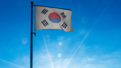 Flag of South Korea against the blue sky with sun rays. Diplomacy concept. International relations.