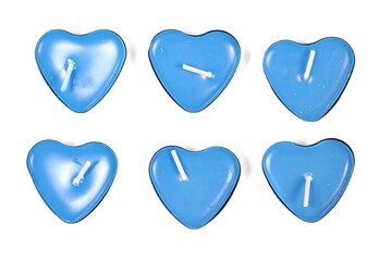 Set tea light candles in shape heart aluminum candle holders isolated on white background, top view