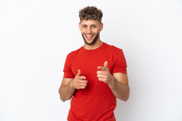 Young caucasian handsome man isolated on white background pointing to the front and smiling