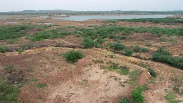 Drone shot of a lake in dry arid land
