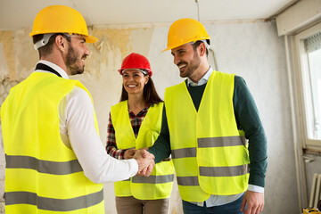 Engineers shaking hands at the construction site